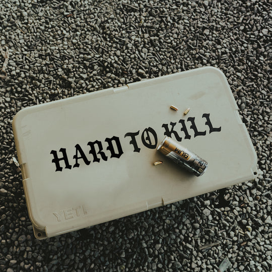 GBRS Group Hard To Kill Transfer Sticker on top of a large cooler with Bum Energy Can on top. - Lifestyle shot.