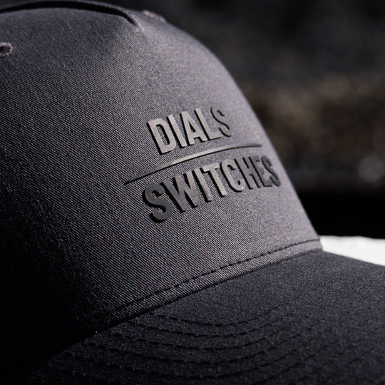 GBRS Group Dials Over Switches Trucker Hat - Close up detail of front lettering