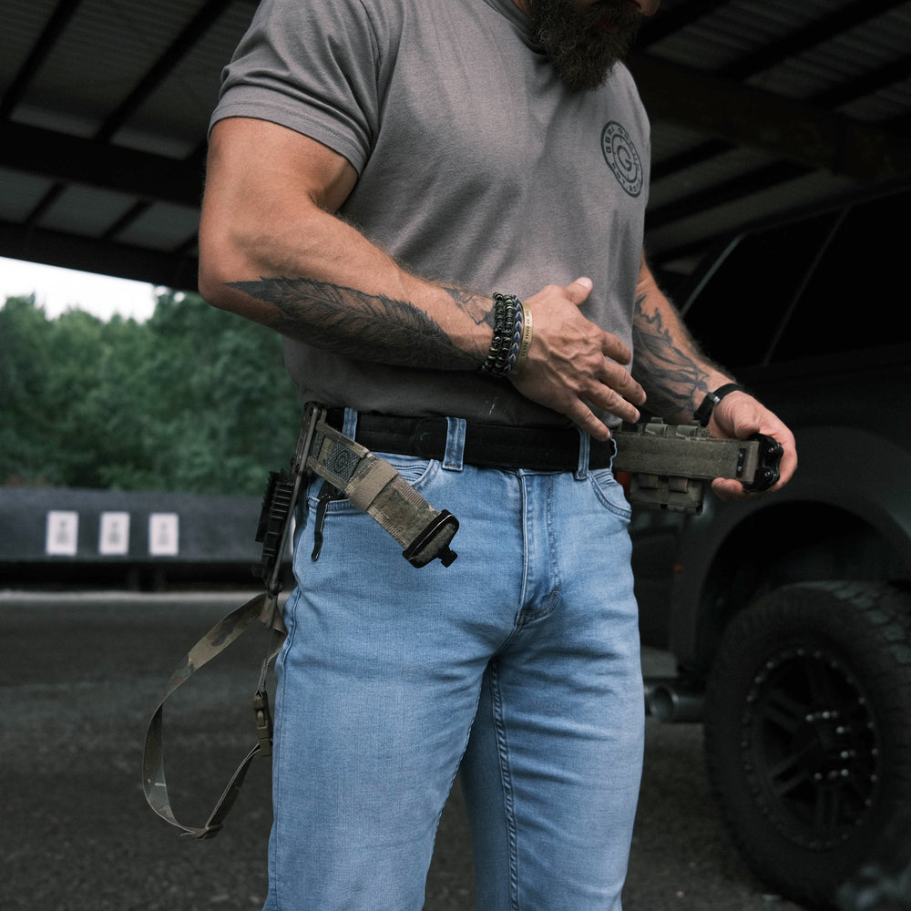 GBRS Group Assaulter Belt System V3 is a 2-belt system - lifestyle shot of a man putting on the belt system