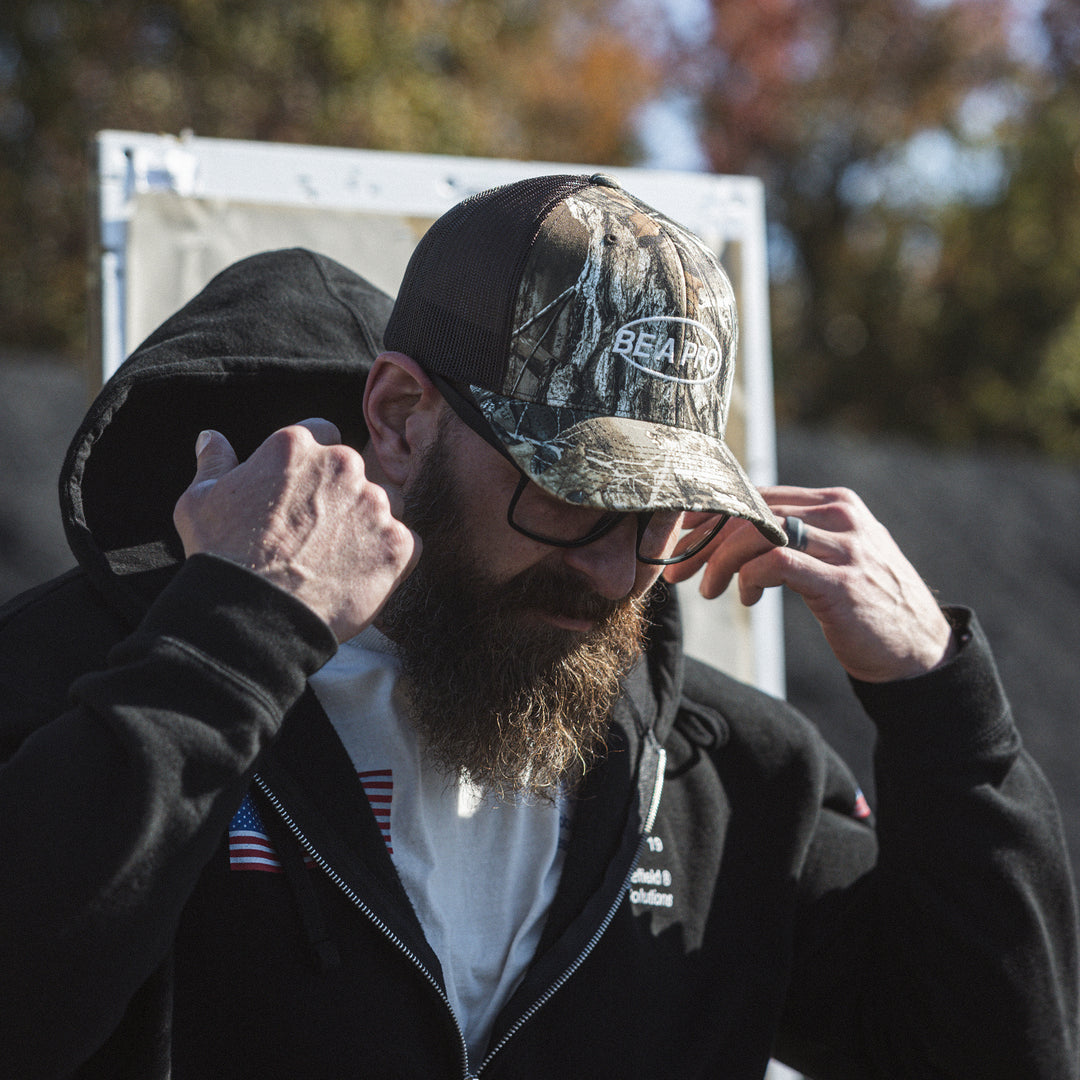 GBRS Group Be A Pro Trucker Hat in Realtree Camo - lifestyle image showing side of hat