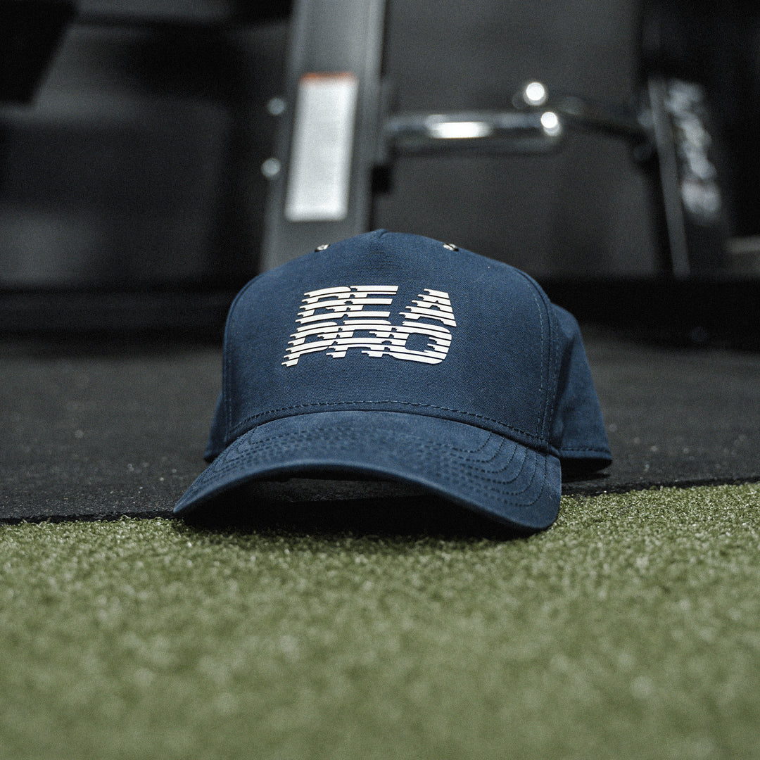 GBRS Group Be A Pro Canvas Trucker Hat Pictured in a gym background