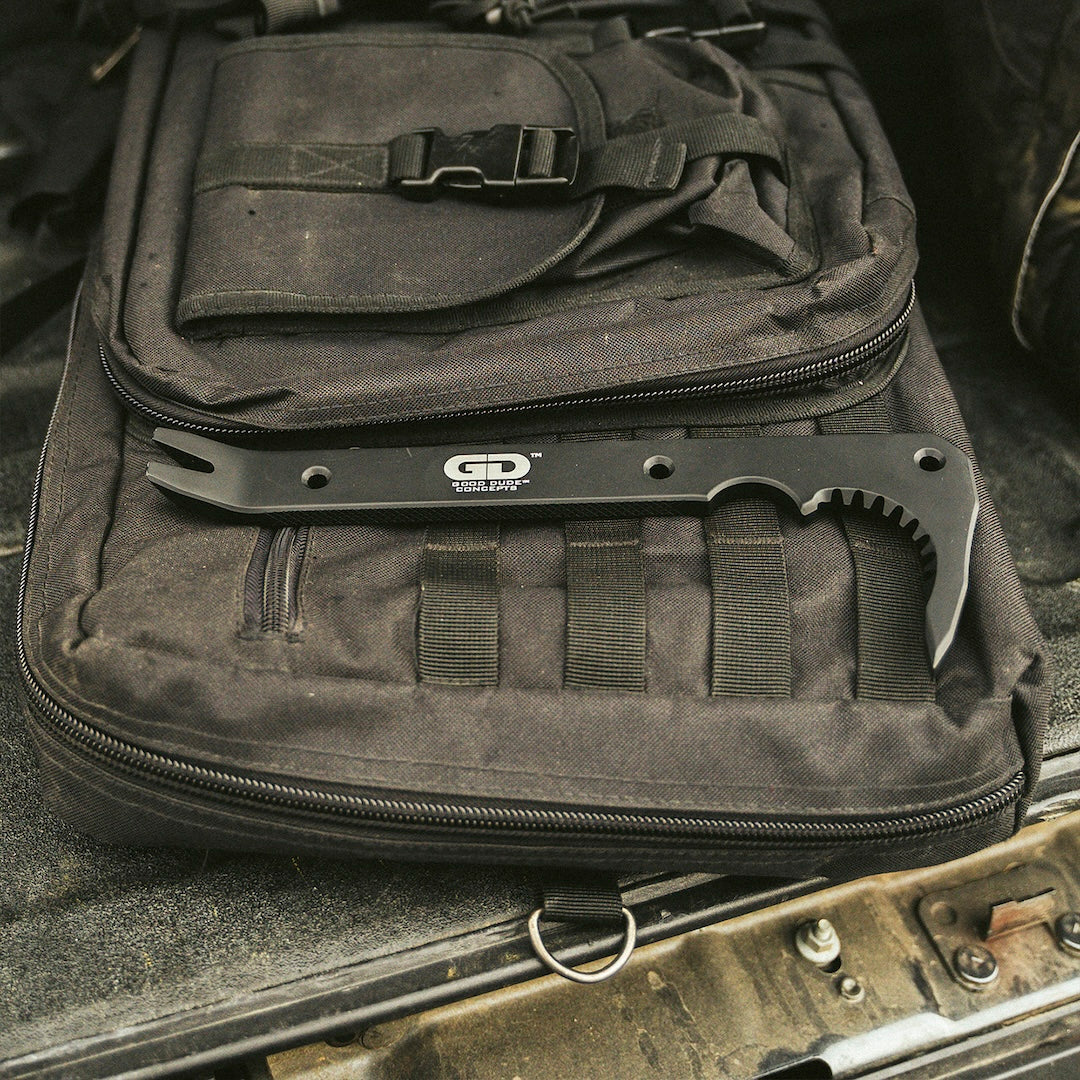 Black metal tool bar resting on a black tactical bag.