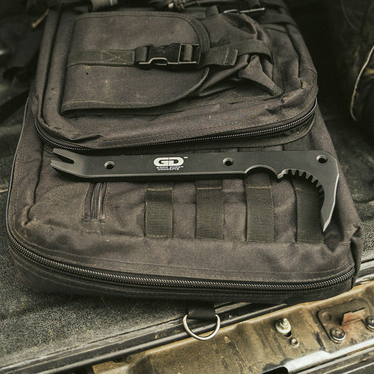 Black metal tool bar resting on a black tactical bag.