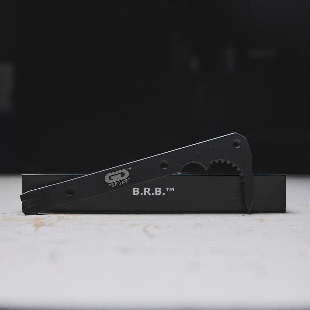 Black metal tool bar and its packaging on a white surface.