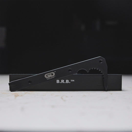 Black metal tool bar and its packaging on a white surface.