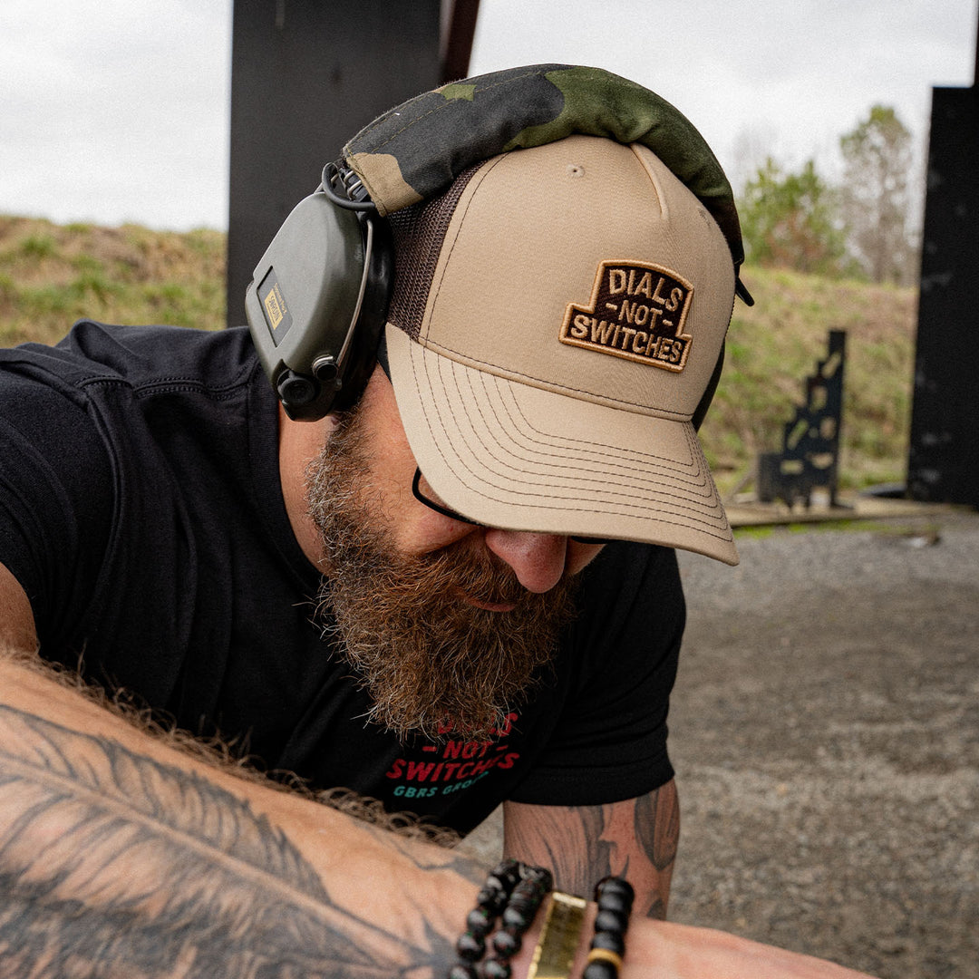 GBRS Group Badge Trucker Hat in Khaki  - Front of hat lifestyle shot at the range