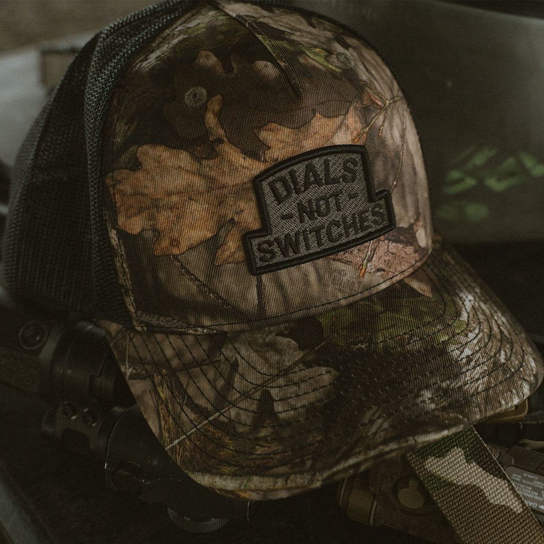 GBRS Group Badge Trucker Hat in Mossy Oak - Front View - Lifestyle Shot
