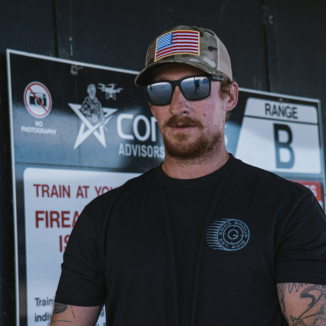 GBRS Group Patriotism Trucker Hat - Lifestyle shot picturing front of Multicam hat with embroidered Flag