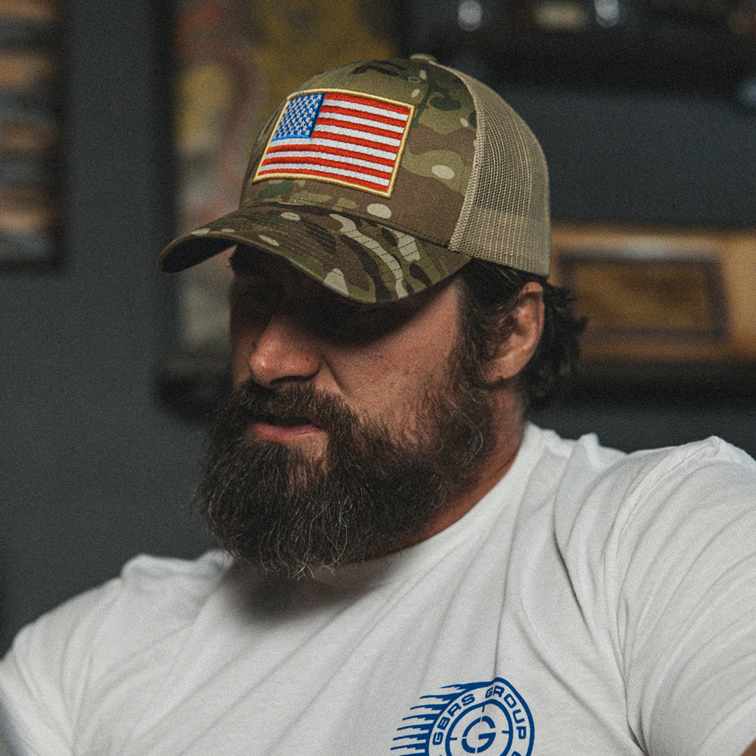 GBRS Group Patriotism Trucker Hat - Lifestyle shot picturing front of Multicam hat with embroidered Flag