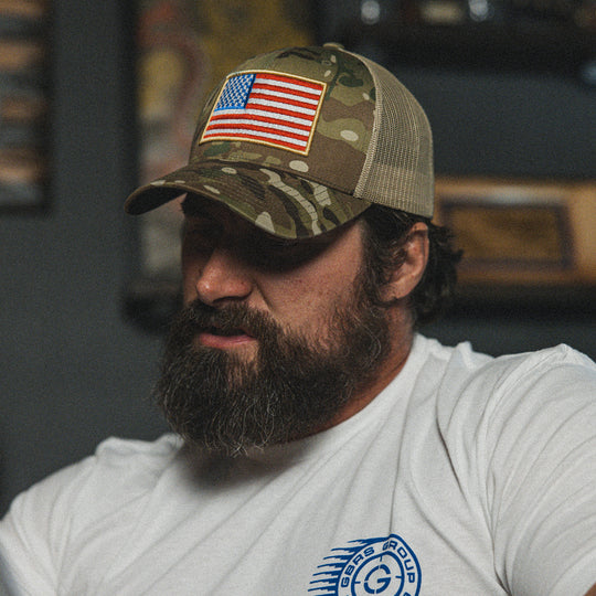 GBRS Group Patriotism Trucker Hat - Lifestyle shot picturing front of Multicam hat with embroidered Flag