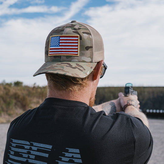 GBRS Group Patriotism Trucker Hat - Lifestyle shot picturing front of Multicam hat with embroidered Flag