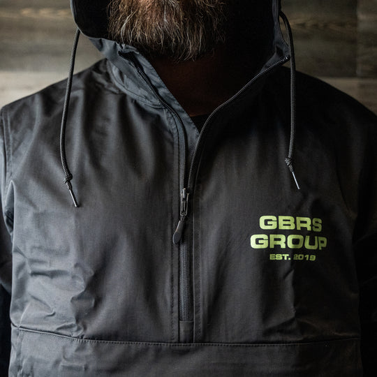GBRS Group Instructor Rain Jacket - with  Level 3 waterproofing. Black with Green ink. - LIfestyle image outdoors
