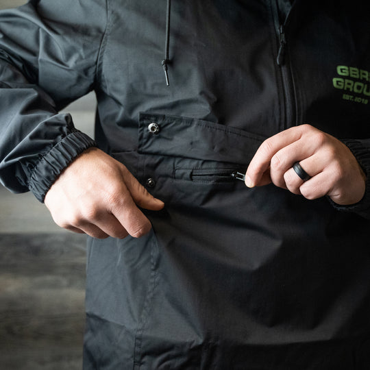 GBRS Group Instructor Rain Jacket - with  Level 3 waterproofing. Black with Green ink. - LIfestyle image outdoors
