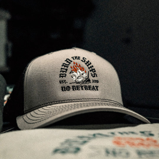 GBRS Group No Retreat Trucker Hat is a Richardson 112FP with Classic Trucker vibes. Front embroidered Burn the Ships No Retreat logo. Back embroidered GBRS "g" logo. 