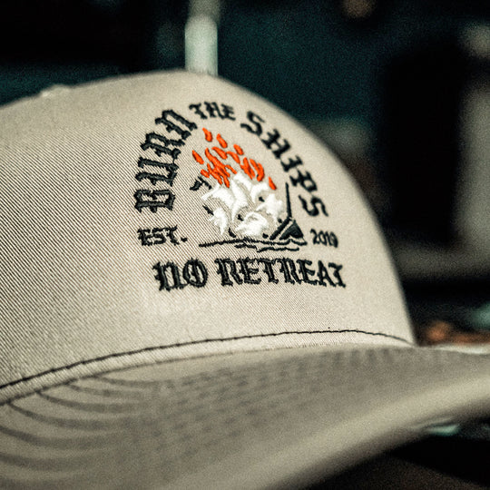 GBRS Group No Retreat Trucker Hat is a Richardson 112FP with Classic Trucker vibes. Front embroidered Burn the Ships No Retreat logo. Back embroidered GBRS "g" logo. 