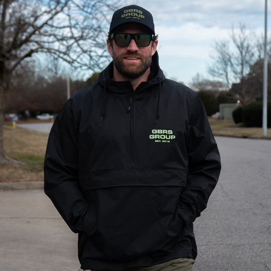 GBRS Group Instructor Rain Jacket - Anniversary Edition with  Level 3 waterproofing. Black with Green ink. - LIfestyle image outdoors
