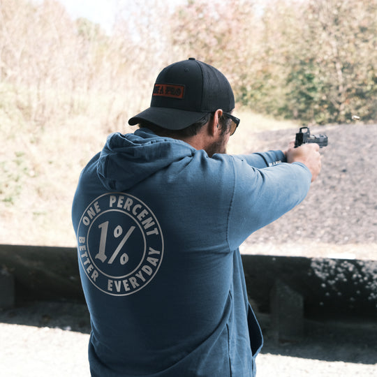 GBRS Group 1% Better Pull Over Hoodie lifestyle picture at the range. 1% Better Everyday - serves as a constant reminder that you should set yourself up to be better than the person you were yesterday. 