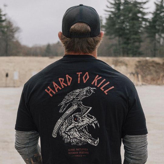 Model wearing the GBRS Group Hard to Kill Death Grip Short Sleeve in an outdoor environment, showing the design on the back