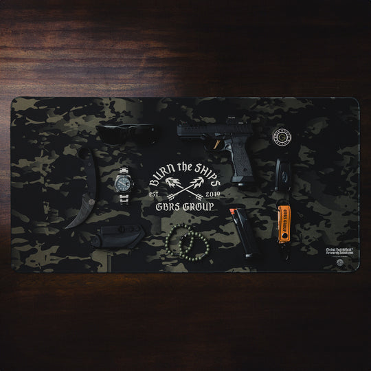 GBRS Group Burn The Ships Work Mat - Lifestyle image on a desk with random items on top