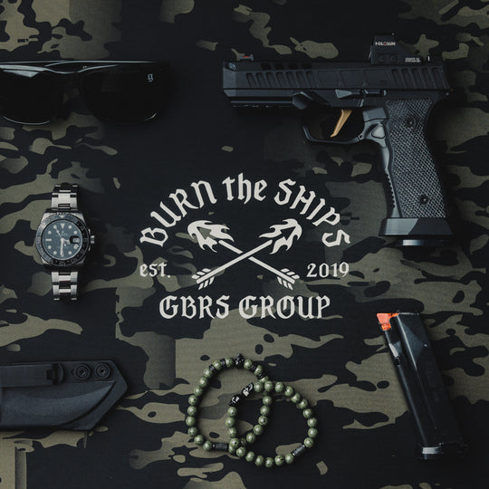 GBRS Group Burn The Ships Work Mat - Lifestyle image on a desk with random items on top