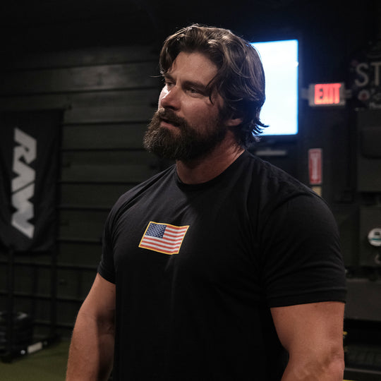 GBRS Group Patriotism Front & Center Short Sleeve Shirt - Screen printed center chest American Flag design - Lifestyle photo in a gym.