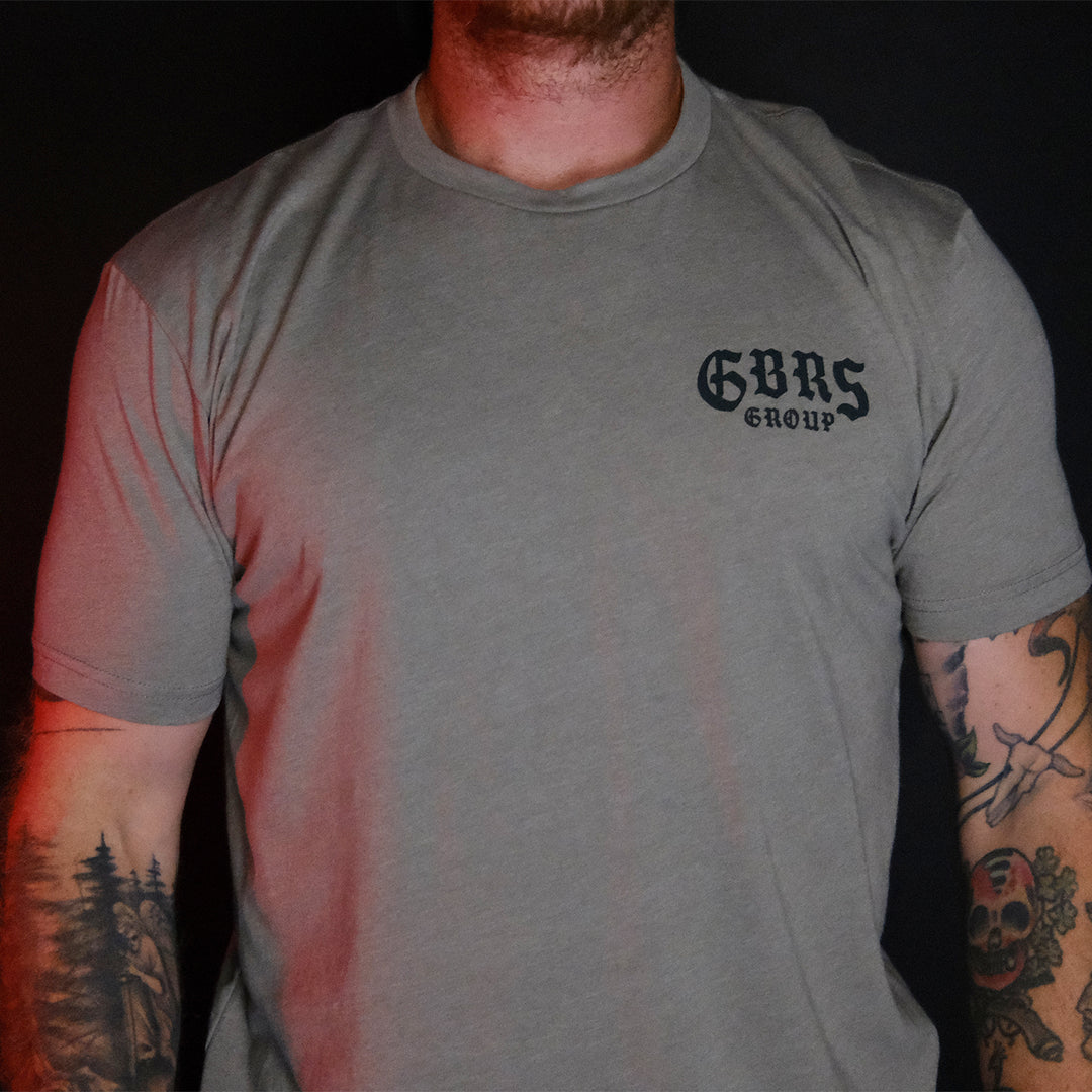 GBRS Group Hard To Kill Short Sleeve Shirt - front of stone colored shirt on a man with tatoos.
