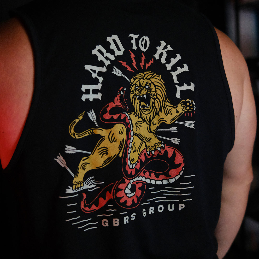 GBRS Group Hard To Kill Tank on a mans body - back of tank design in a dark room
