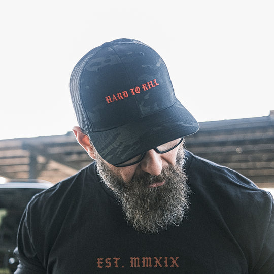 GBRS Group Multicam Hard To Kill Tactical Trucker Hat - Richardson 862 Tactical Trucker with NYCO ripstop fabric - Man wearing hat showing the front in a lifestyle range photo