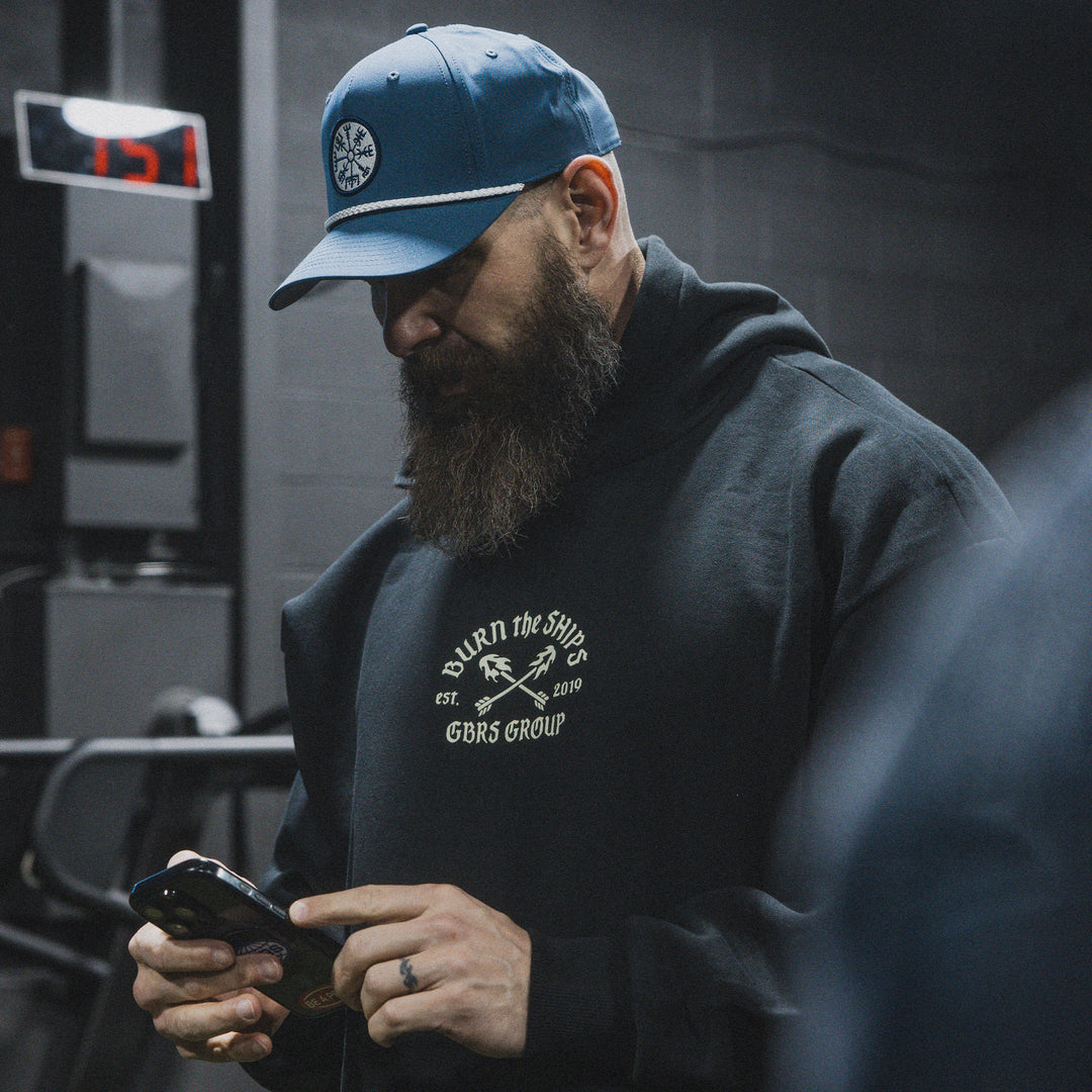 GBRS Group No Retreat Oversized Pullover Hoodie- Lifestyle image in a gym  showing front of hoodie