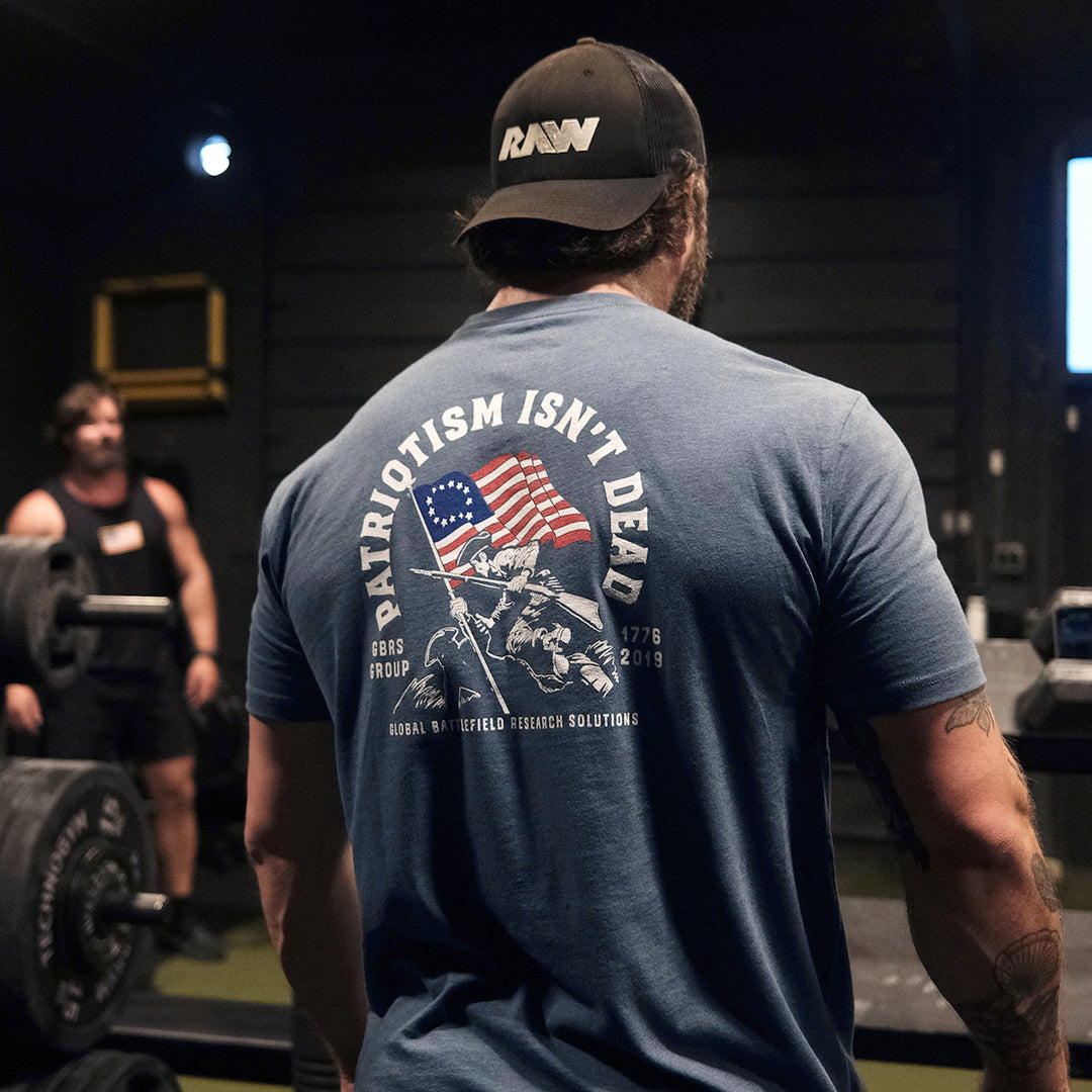 GBRS Group Patriotism Isn't Dead Short Sleeve Shirt  - Screen printed Patriotism Isn't Dead center backprint design- Indigo Blue, Lifestyle image in a gym