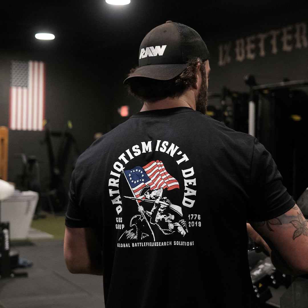 GBRS Group Patriotism Isn't Dead Short Sleeve Shirt  - Screen printed Patriotism Isn't Dead center backprint design- Black, Lifestyle image in a gym