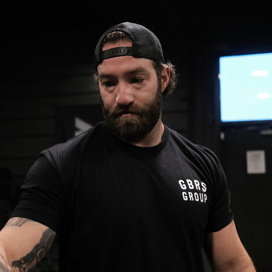 GBRS Group Patriotism Isn't Dead Short Sleeve Shirt  - Screen printed left chest GBRS Group stacked design- Lifestyle on body image in a gym atmosphere.