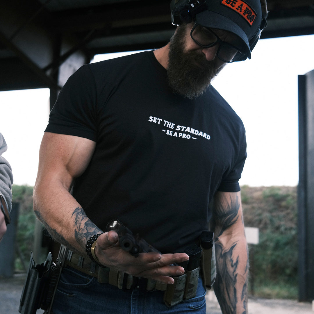 GBRS Group Set The Standard Short Sleeve Shirt. Lifestyle shot at the range. Be A Pro - A mindset to elevate your performance, keep you focused, and help spark motivation in others to foster the same mentality.