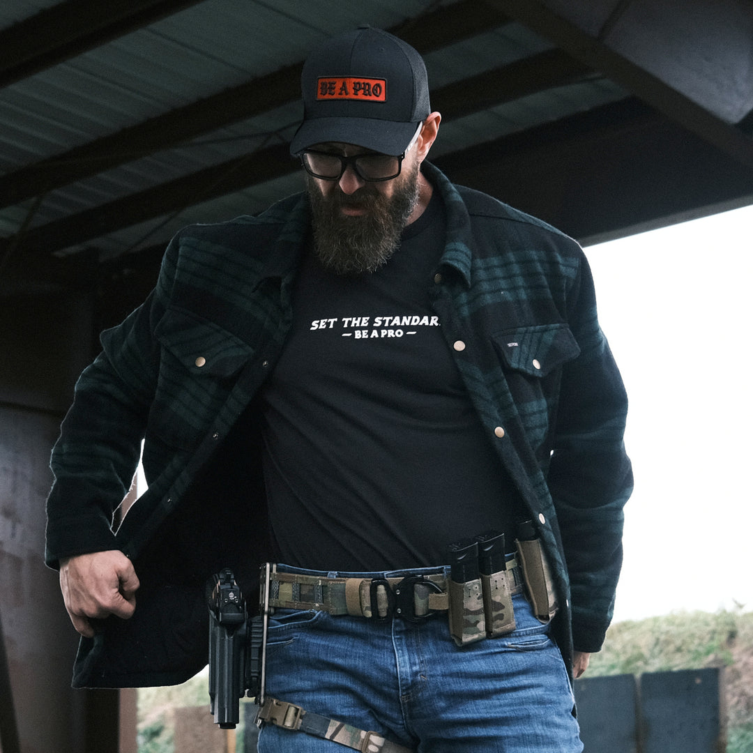 GBRS Group Set The Standard Short Sleeve Shirt. Lifestyle shot at the range. Be A Pro - A mindset to elevate your performance, keep you focused, and help spark motivation in others to foster the same mentality.