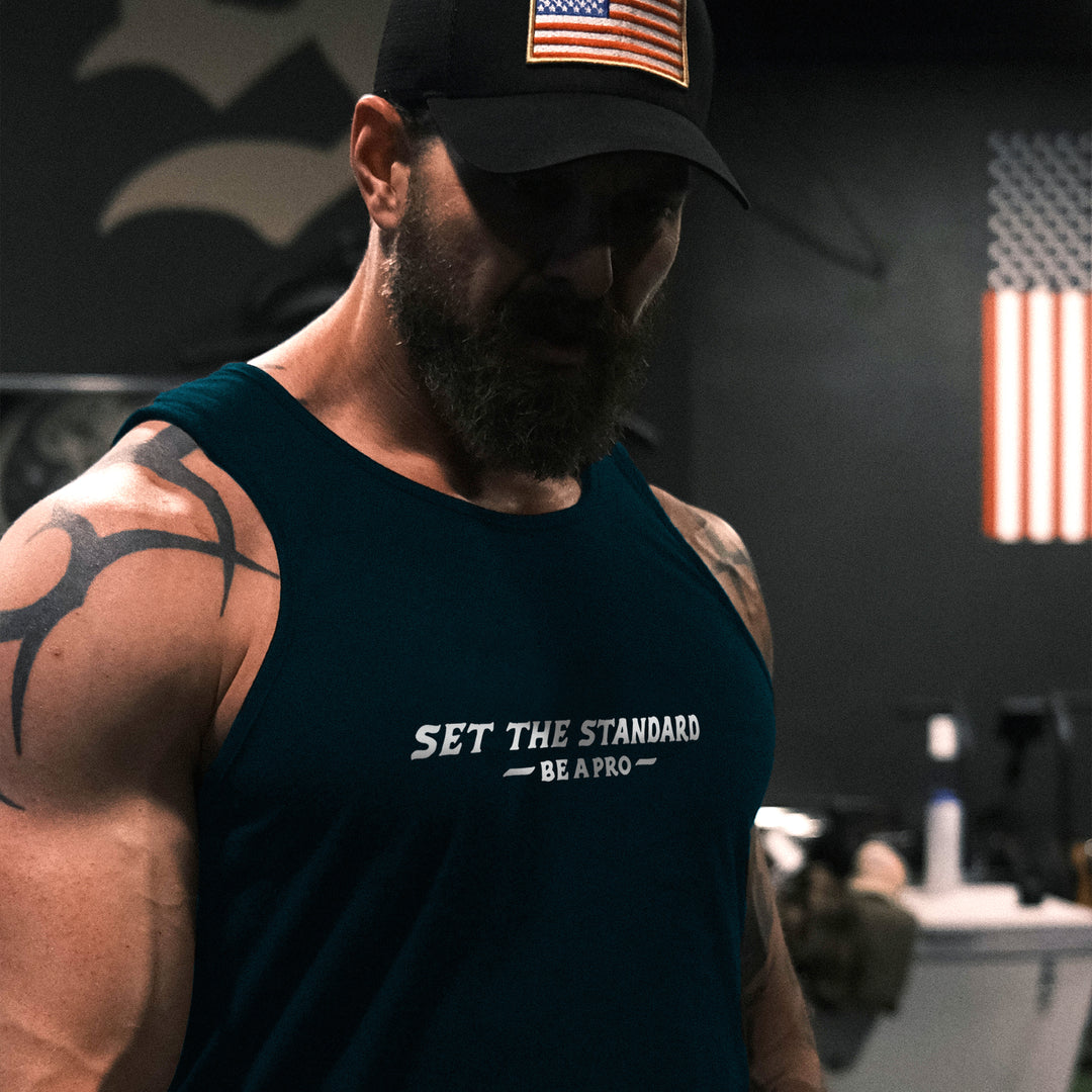 GBRS Group Set The Standard Tank lifestyle shot in a gym.  Be A Pro is a mindset to elevate your performance, keep you focused, and help spark motivation in others to foster the same mentality.