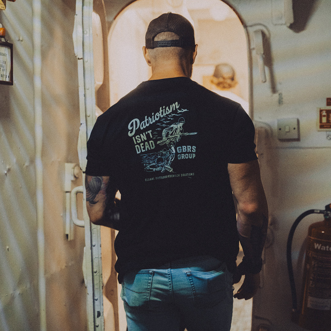 GBRS Group Storming The Beach Short Sleeve Shirt  in Black pictured on body in a lifestyle shot indoors.