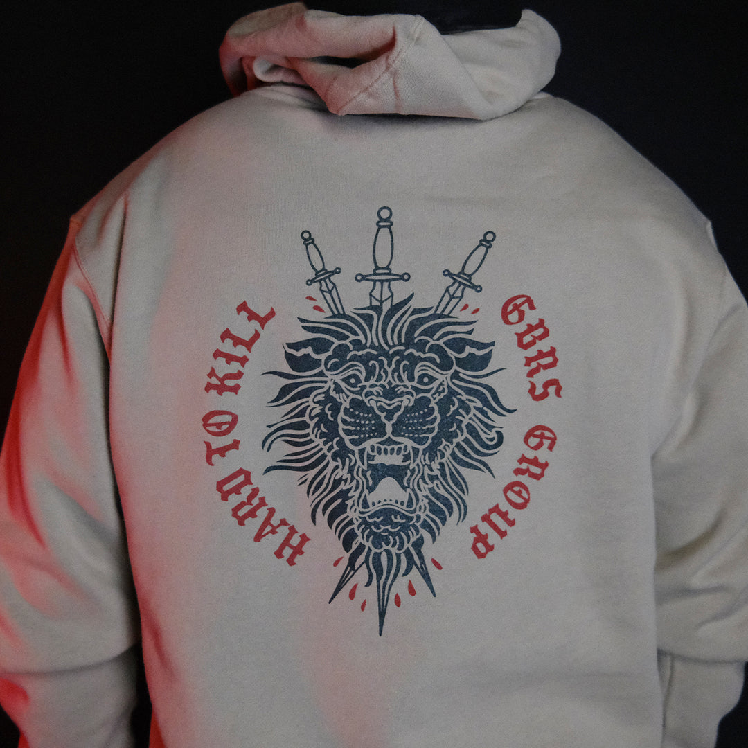 GBRS Group Triple Daggers Pullover Hoodie - Back of Cement colored hoodie on body in dark room
