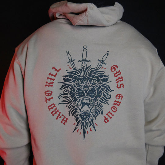 GBRS Group Triple Daggers Pullover Hoodie - Back of Cement colored hoodie on body in dark room
