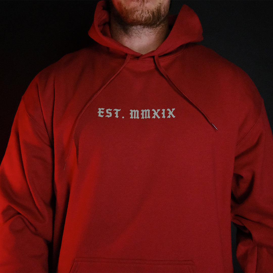 GBRS Group Triple Daggers Pullover Hoodie - Front of Cardinal colored hoodie on body in dark room
