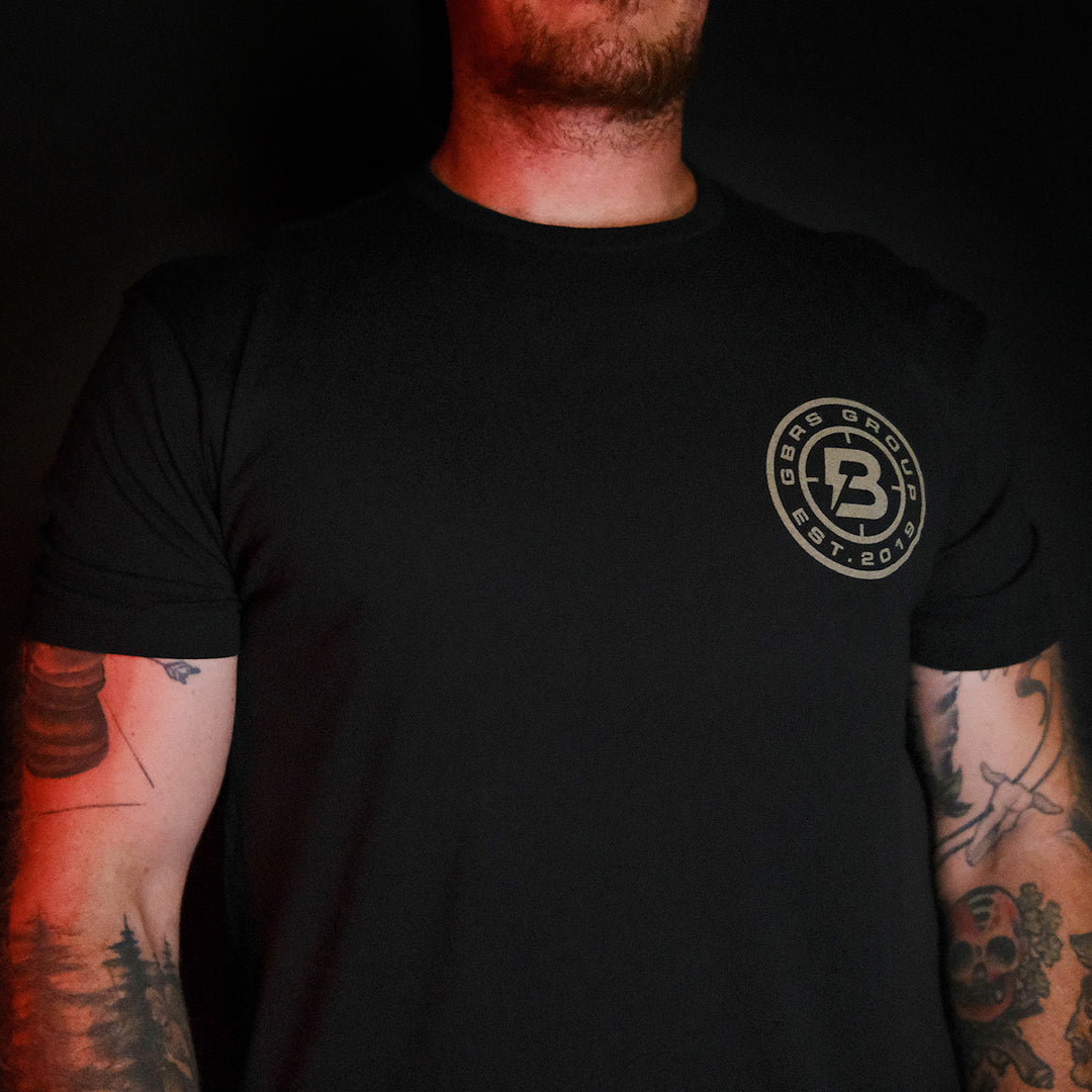 GBRS Group x BUM Energy Collab Grip Matters Short Sleeve Shirt - on body front of shirt in a dark room
