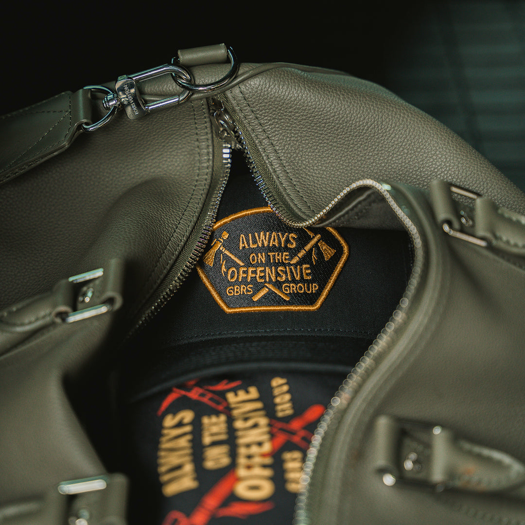 GBRS Group Axes Trucker Hat - Lifestyle image in a duffle bag