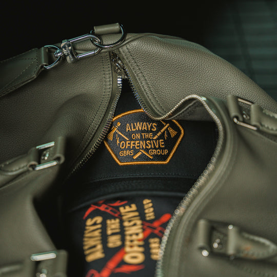 GBRS Group Axes Trucker Hat - Lifestyle image in a duffle bag
