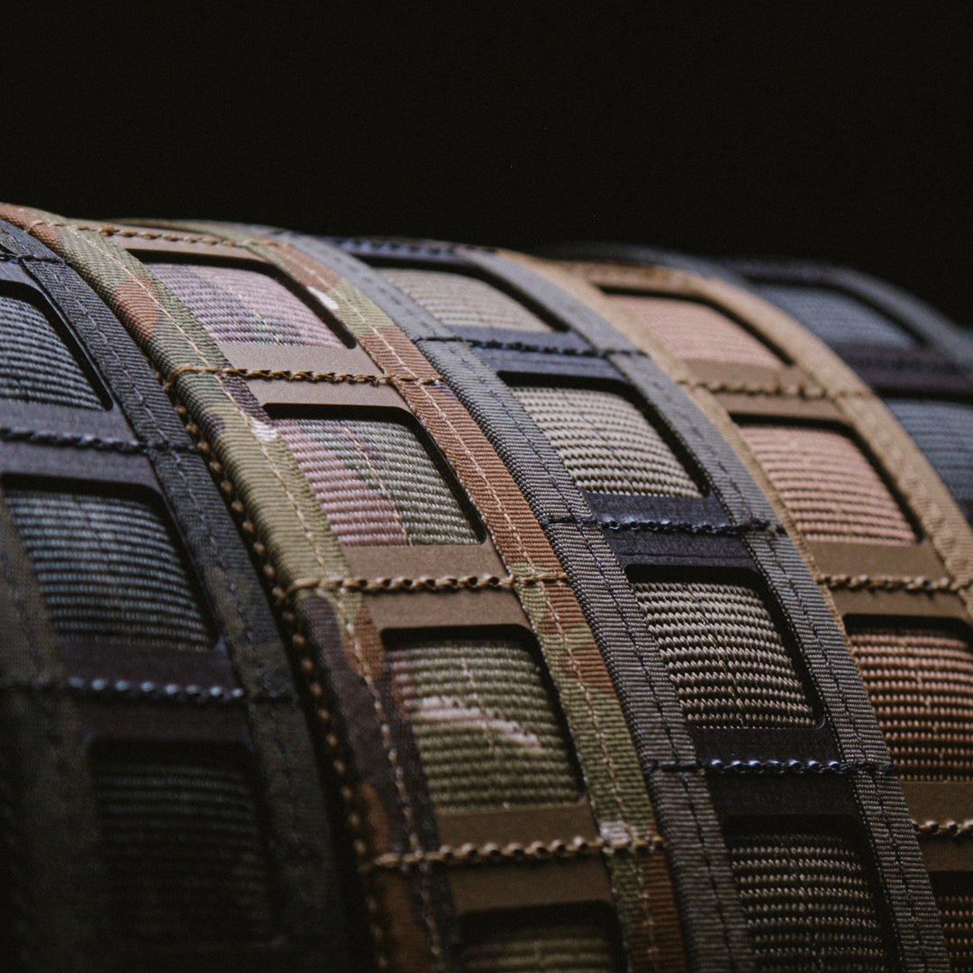 A close-up angled view of GBRS Group Assaulter Belt System V4 in all the colorways lined up next to eachother