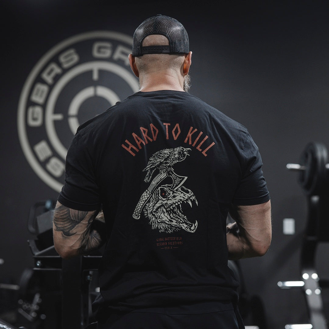 Man wearing the GBRS Group Hard to Kill Axe and Talon Short Sleeve in a gym setting 