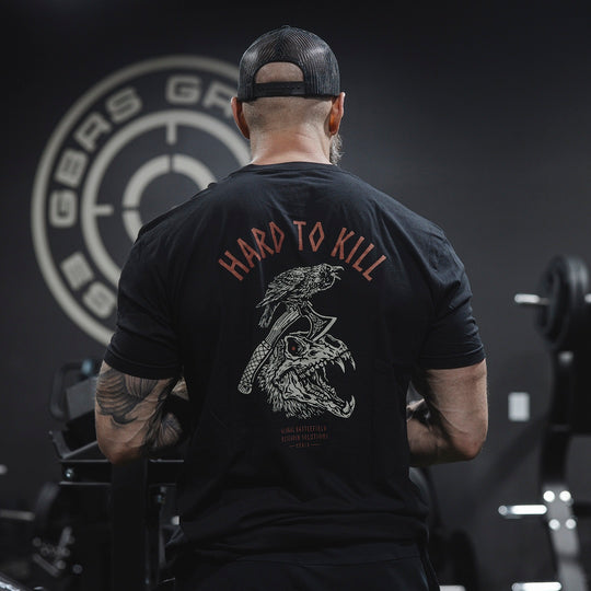 Man wearing the GBRS Group Hard to Kill Axe and Talon Short Sleeve in a gym setting 