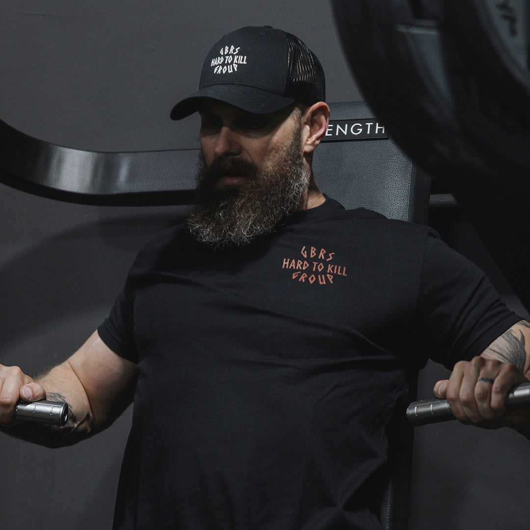 Man wearing the GBRS Group Hard to Kill Axe and Talon Short Sleeve in a gym setting 