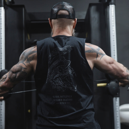 Man wearing GBRS Hard to Kill Axe and Talon Tank in a gym, showing the back design