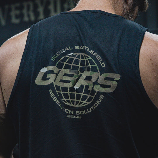 Close-up back view of a man wearing a black tank top with a large multicam 'GBRS' globe logo and the words 'GLOBAL BATTLEFIELD' and 'RESEARCH SOLUTIONS' printed on the back.