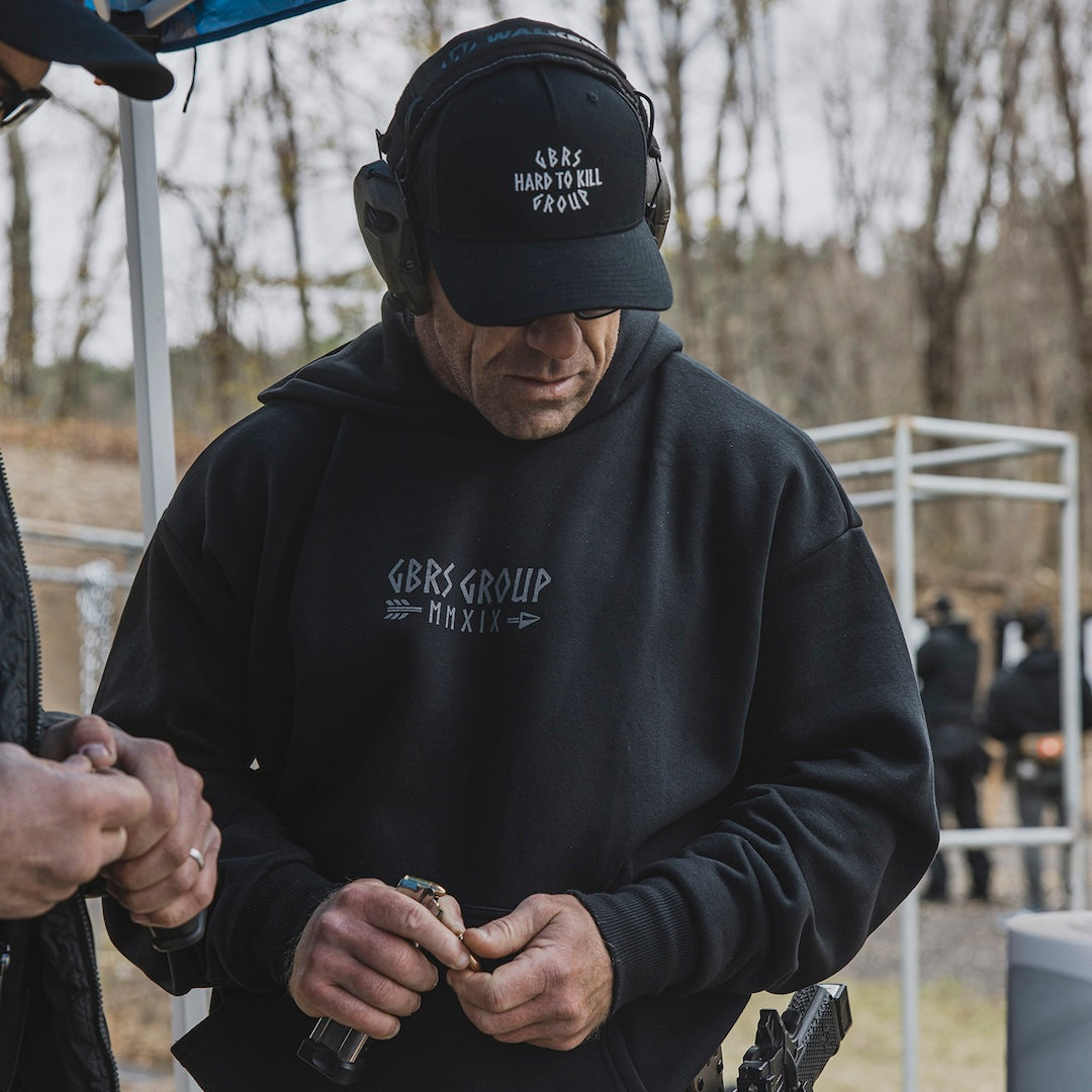 Man wearing the GBRS Group Hard to Kill Oversized Hoodie outdoors