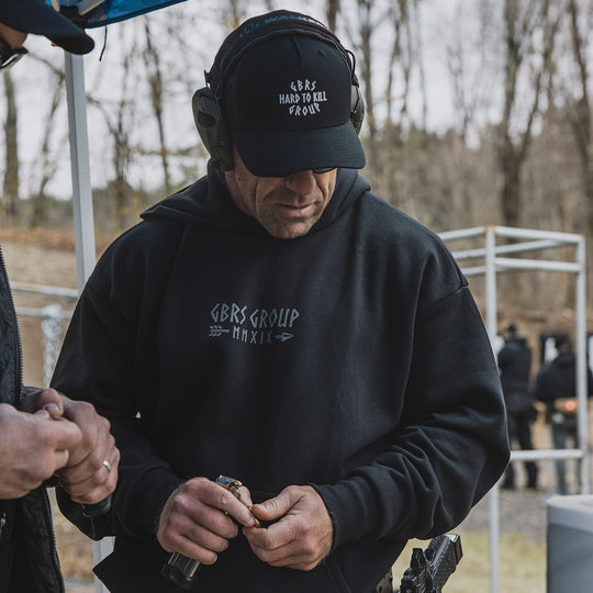 Man wearing the GBRS Group Hard to Kill Oversized Hoodie outdoors